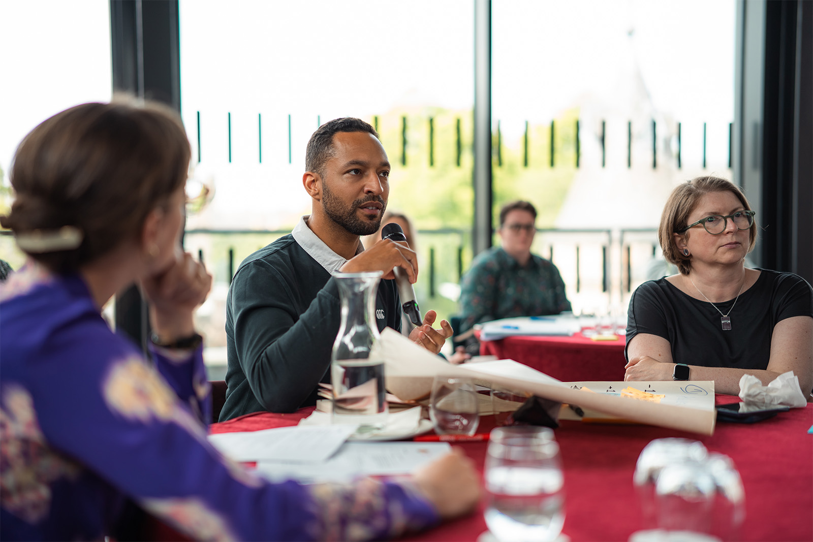 An interactive workshop at the Queer Data Summit, where attendees gathered in groups and engaged in a data mapping exercise.