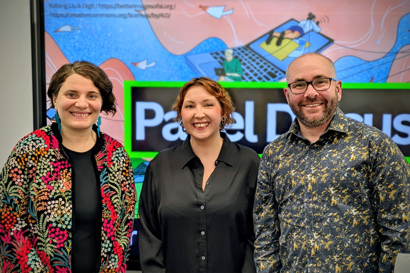 Nazanin Andalibi, Alice Ross and Oliver Haimson stand together for a photo. In the background a screen displays the words 