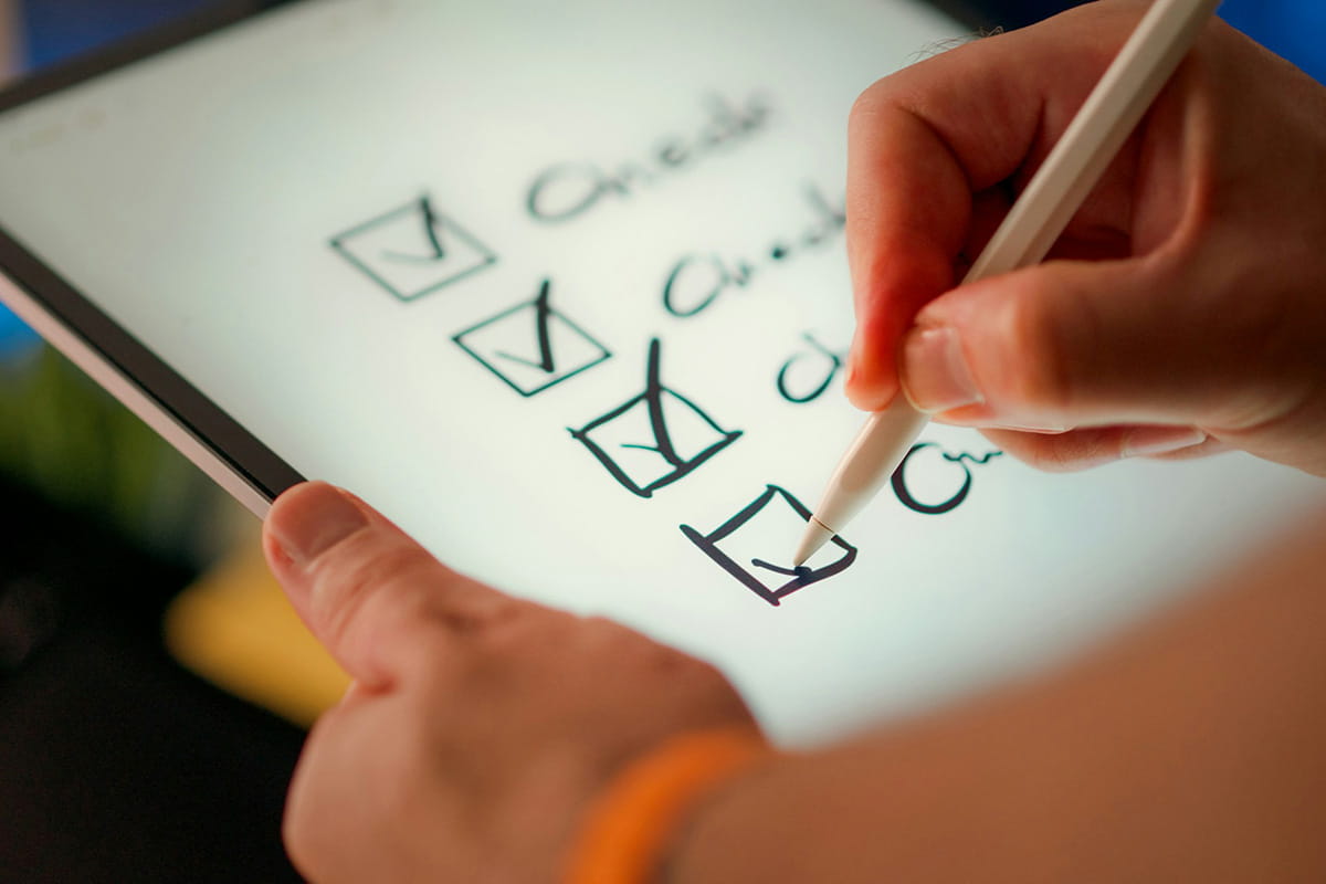 Hand ticking a paper checkbox list